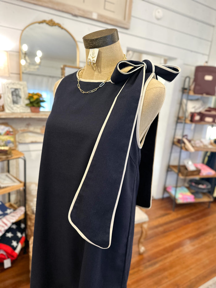 navy dress with cream trim and bow on the side 