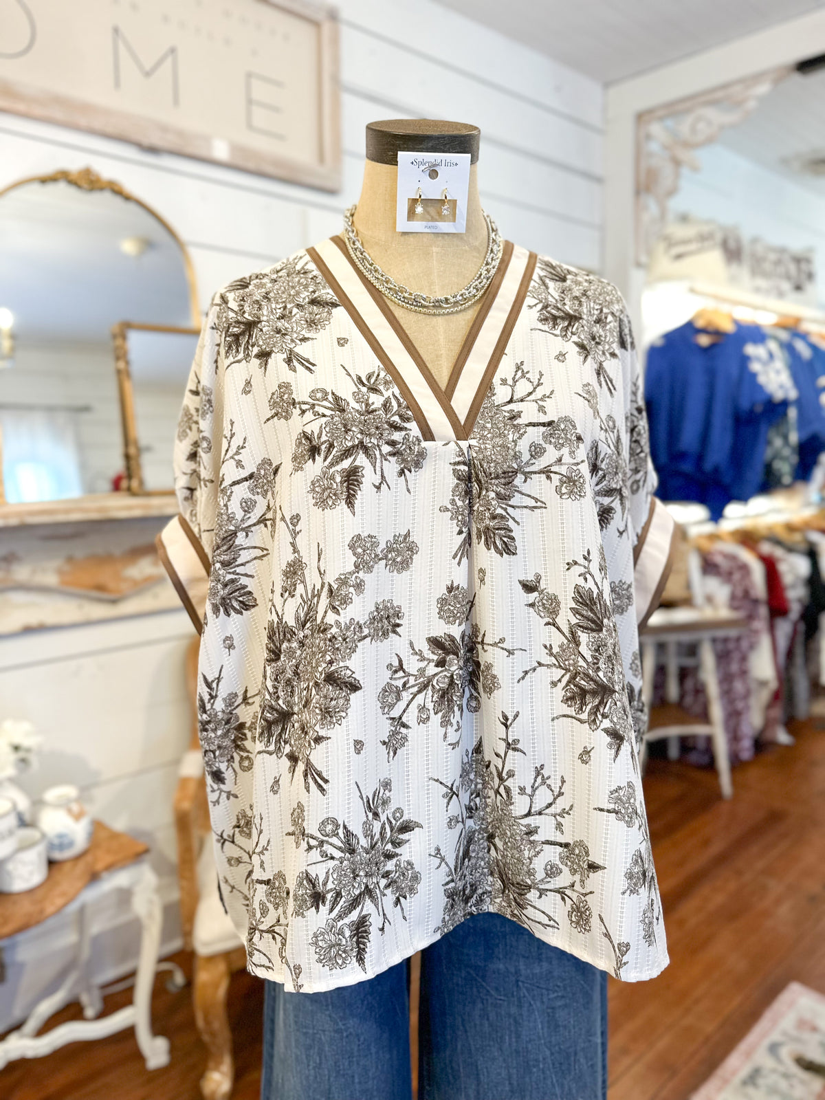 Floral blouse on a mannequin in a store setting