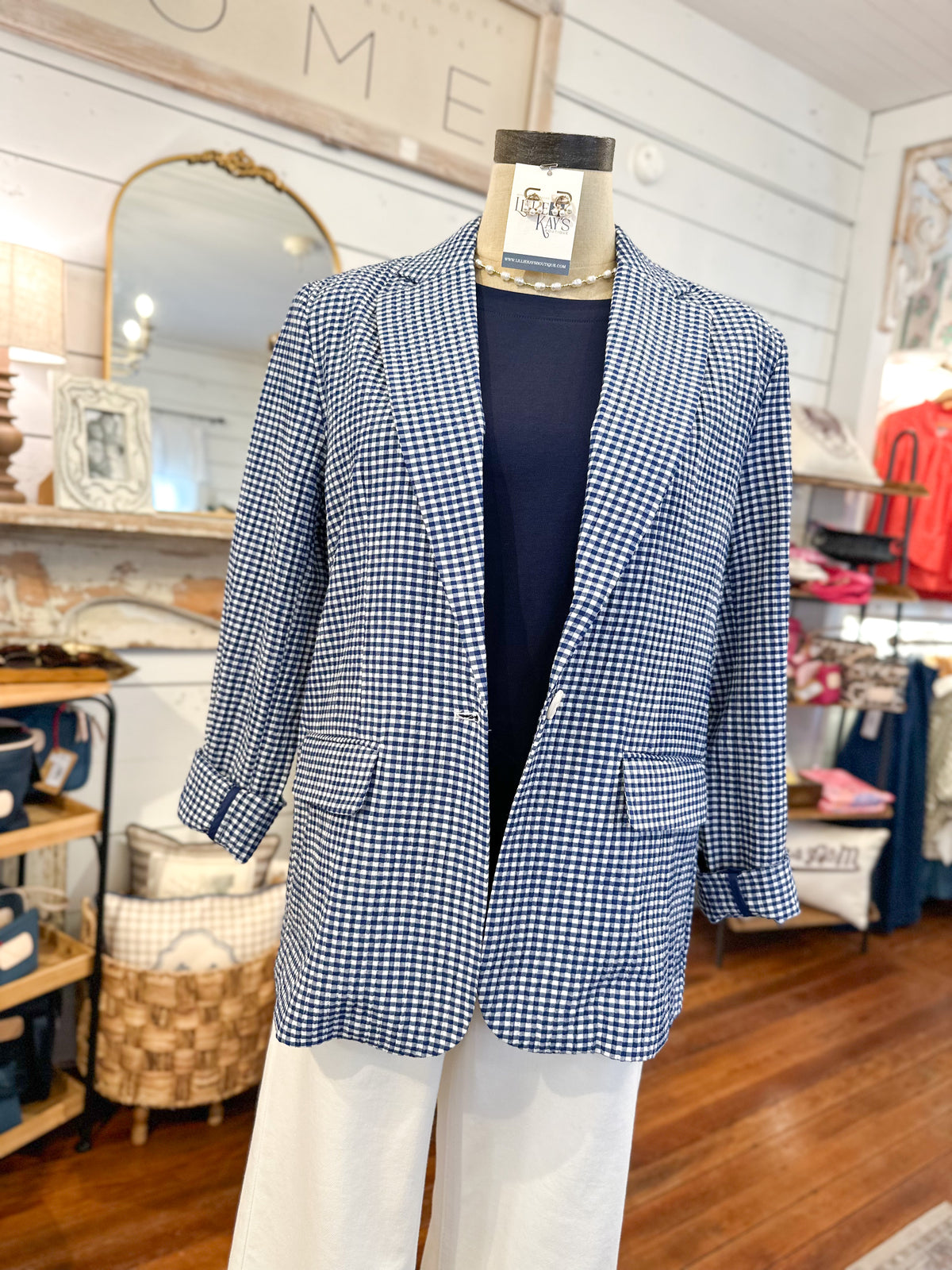 Mannequin wearing a blue checkered blazer in a store setting