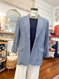 Mannequin wearing a blue checkered blazer in a store setting