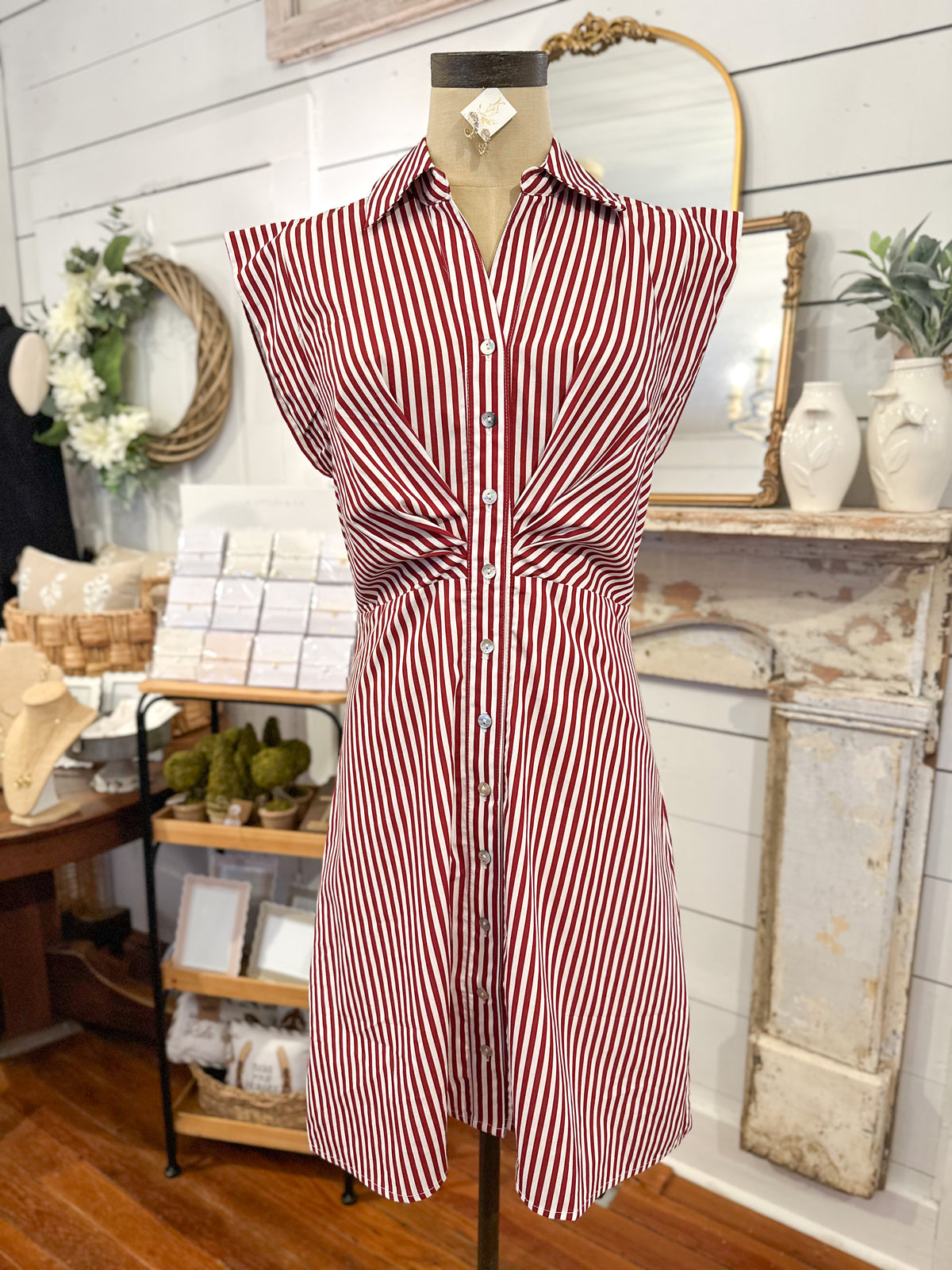 Red and white striped dress on a mannequin in a store setting.