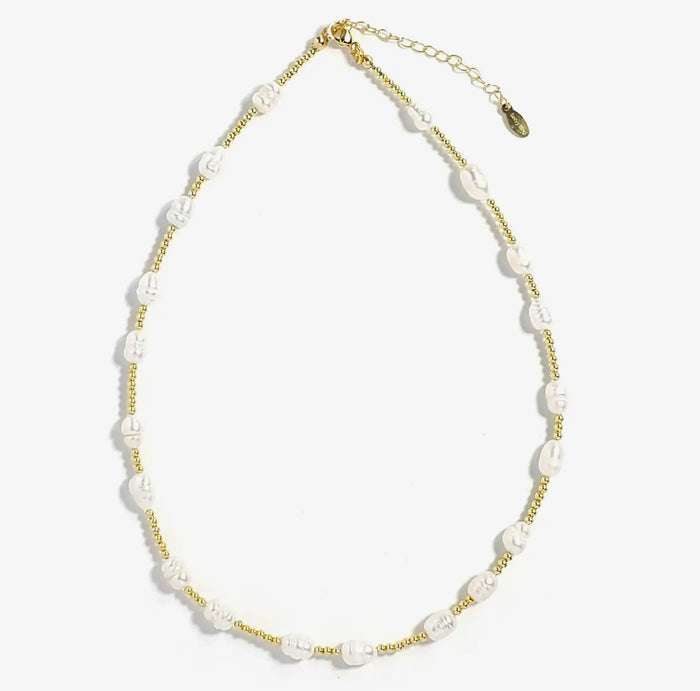 Necklace with white pearl beads and gold chain on a white background