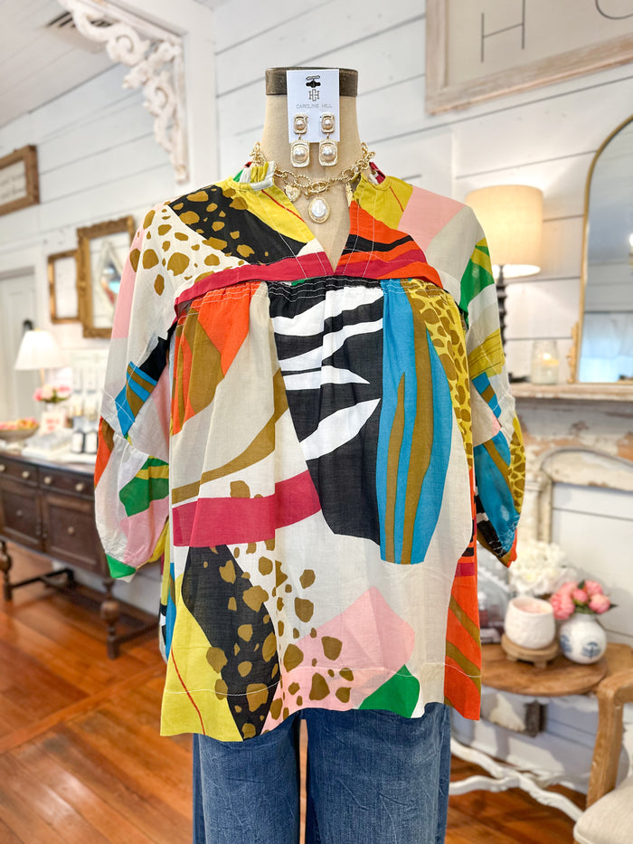 Colorful patterned shirt on a mannequin inside boutique
