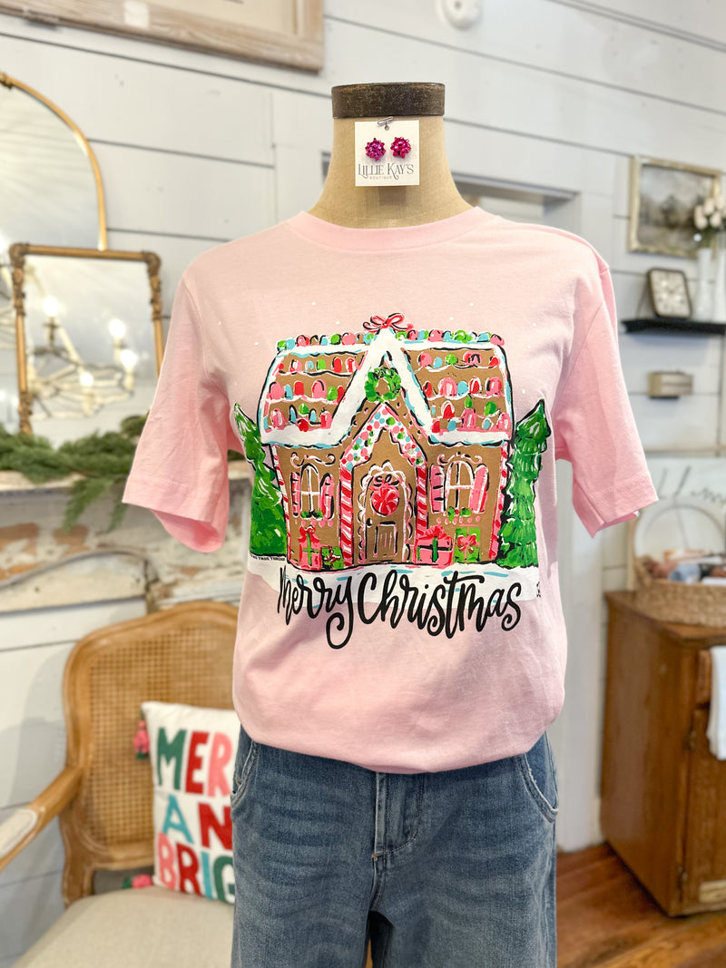 Pink t-shirt with gingerbread house design on a mannequin in a home setting