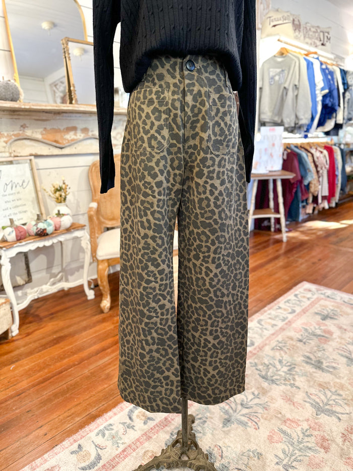 Leopard print pants on a mannequin in a store setting