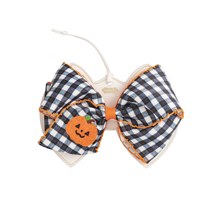 Checkered bow with a pumpkin design on a white background