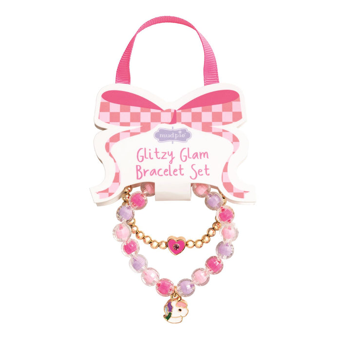 Pink and gold bracelet set with a bow on a white background