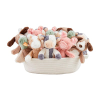 Basket filled with soft toys on a white background