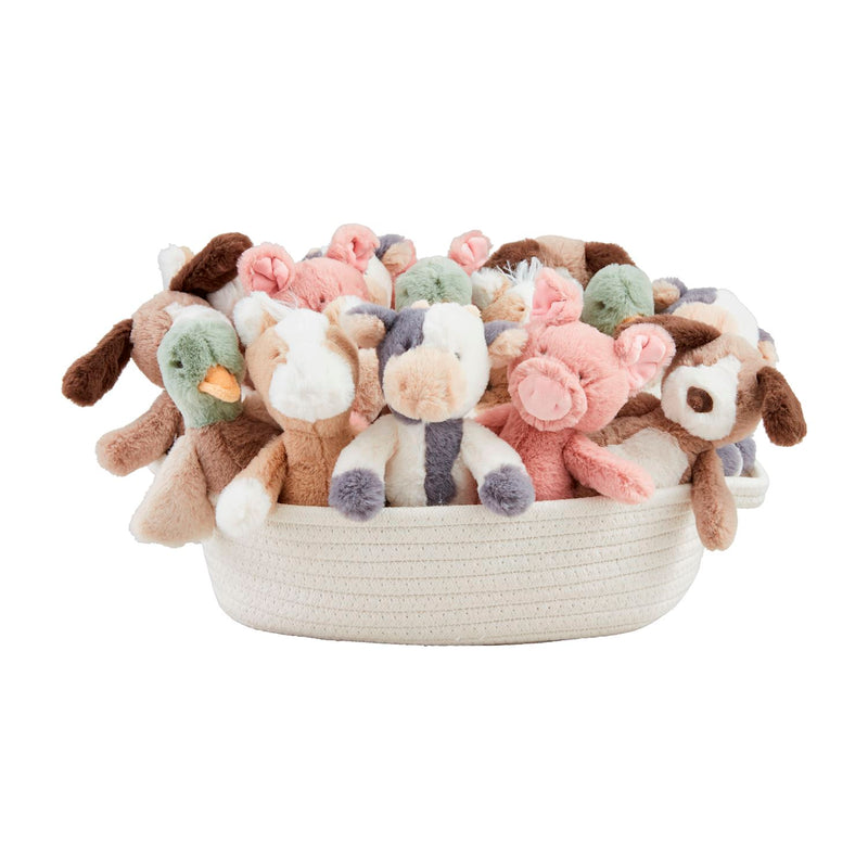 Basket filled with soft toys on a white background