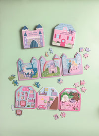 Set of colorful children's puzzles shaped like houses and castles on a light green background