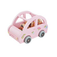Pink toy car with wooden figures inside on a white background