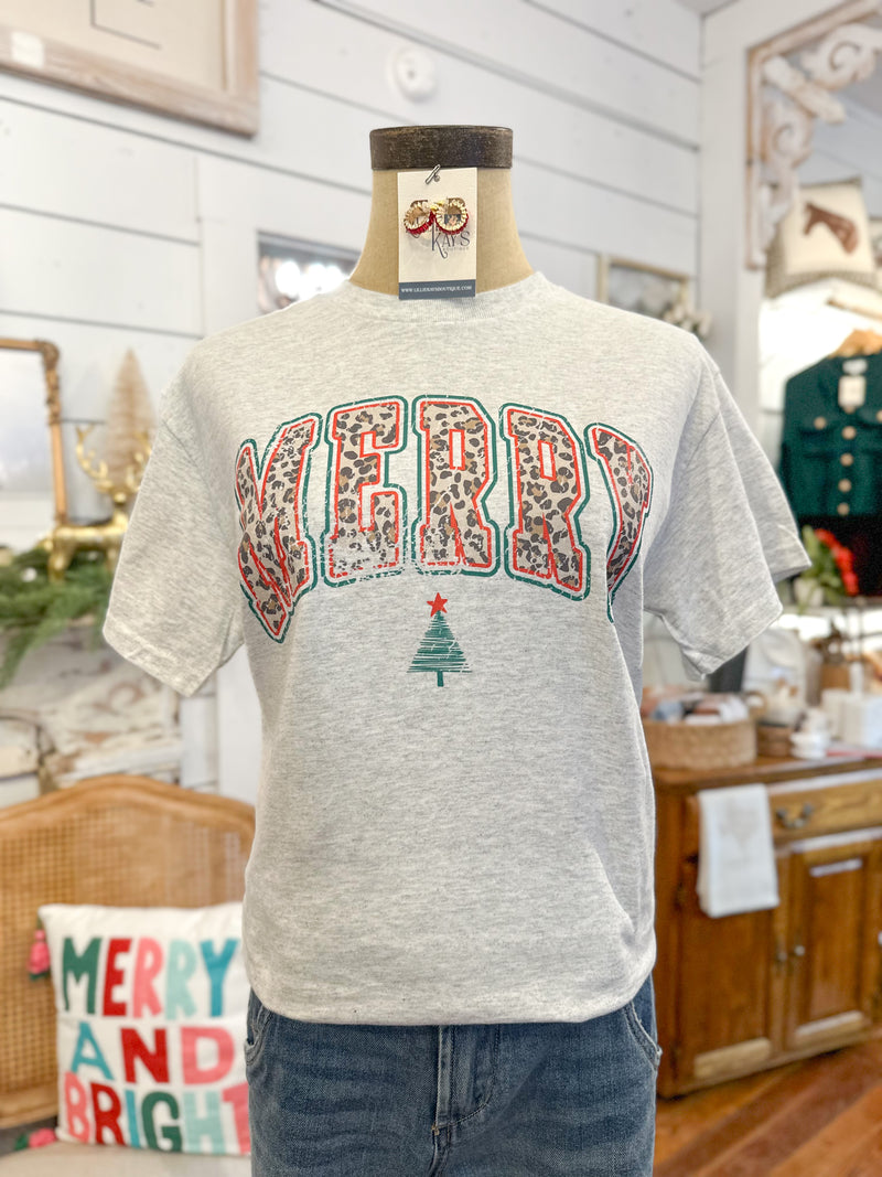 Gray t-shirt with 'Merry and Bright' design on a mannequin in a home setting.