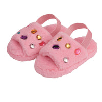 Pink slippers with colorful gemstones on a white background