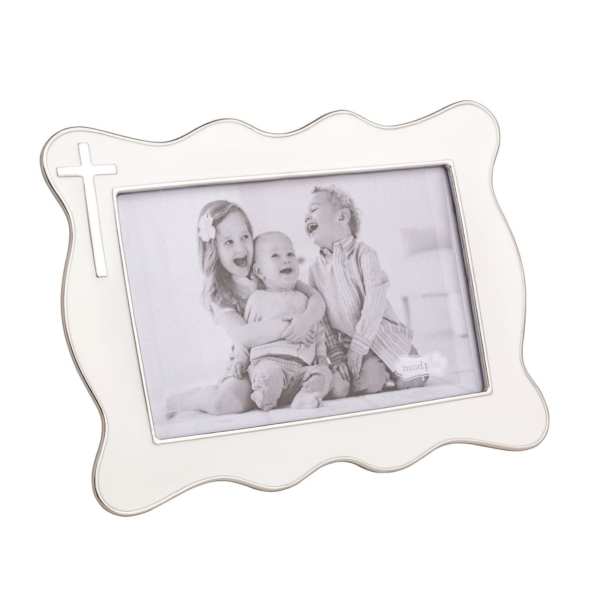 White decorative photo frame with a family photo inside on a white background accent cross in top let corner mud pie