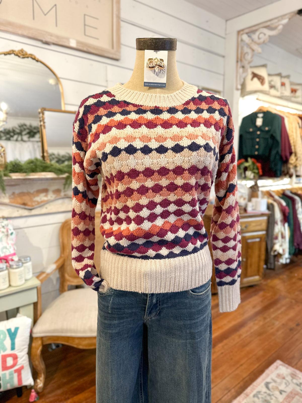 Multicolored patterned sweater on a mannequin in a store setting