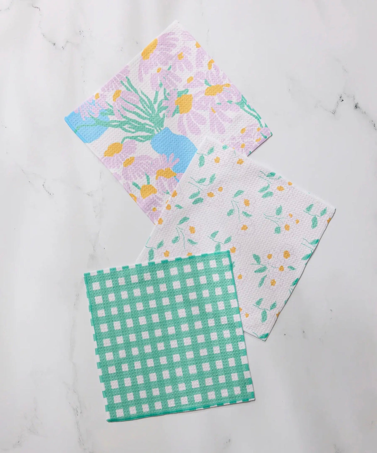 Set of three patterned cloths on a marble surface