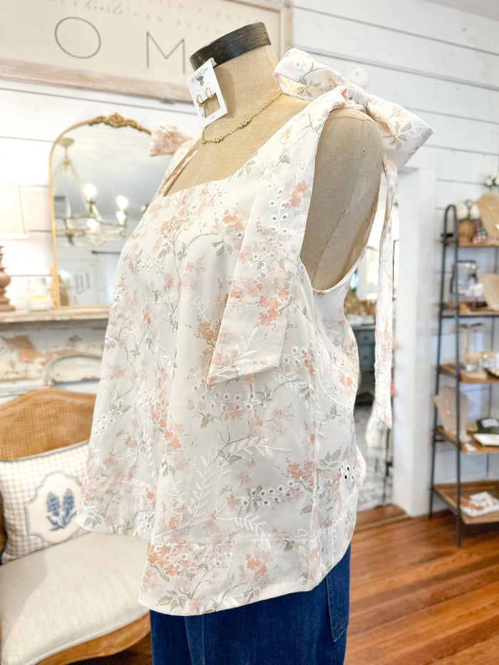 side view of creamy white floral tank top
