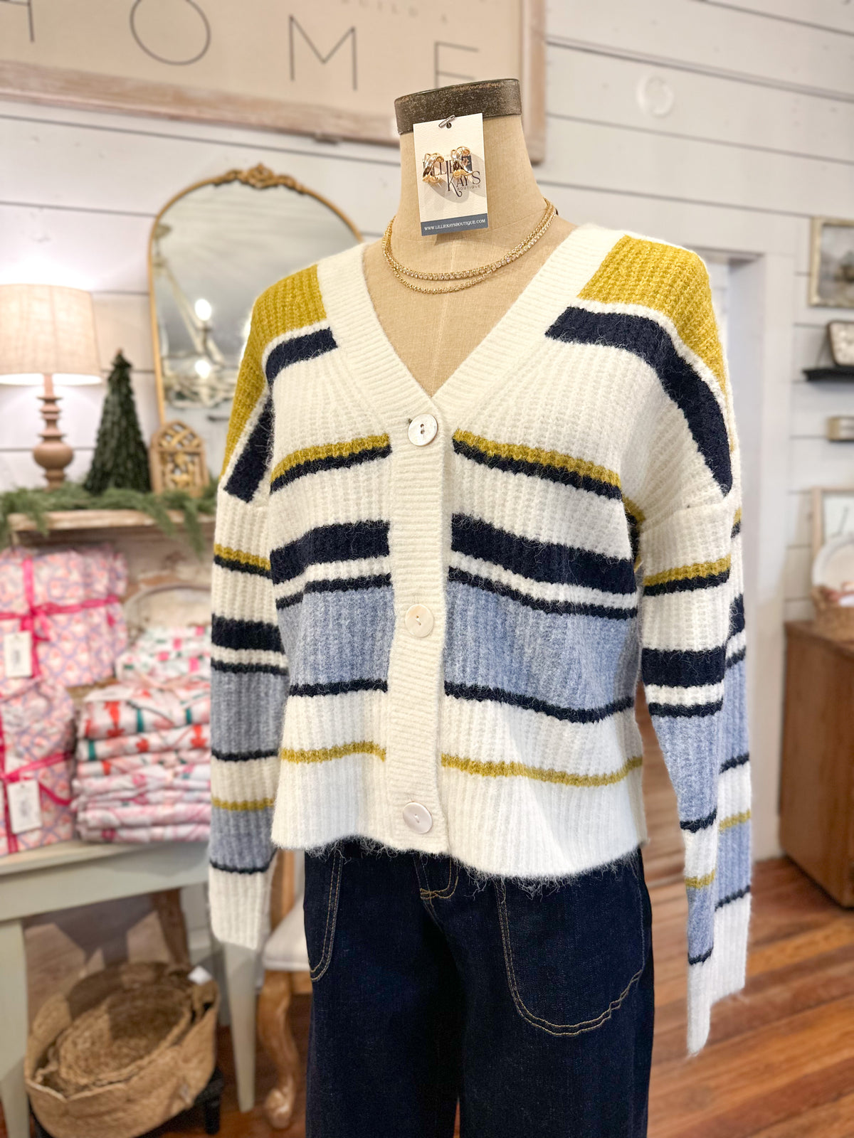 Striped cardigan on a mannequin with a 'Home' sign in the background