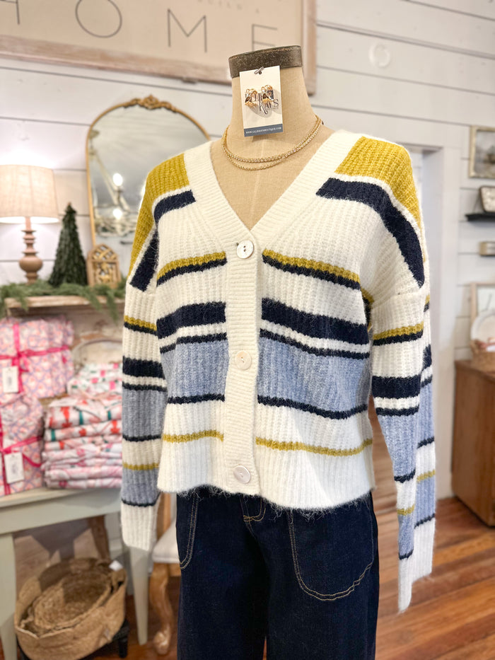 Striped cardigan on a mannequin with a 'Home' sign in the background