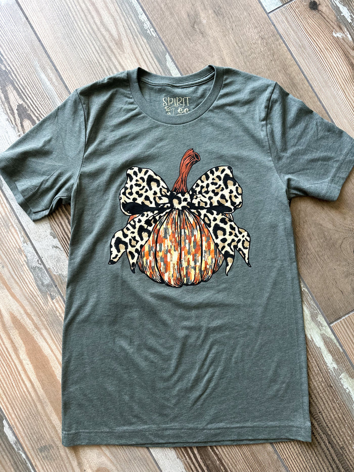 Green t-shirt with a leopard print pumpkin design on a wooden surface