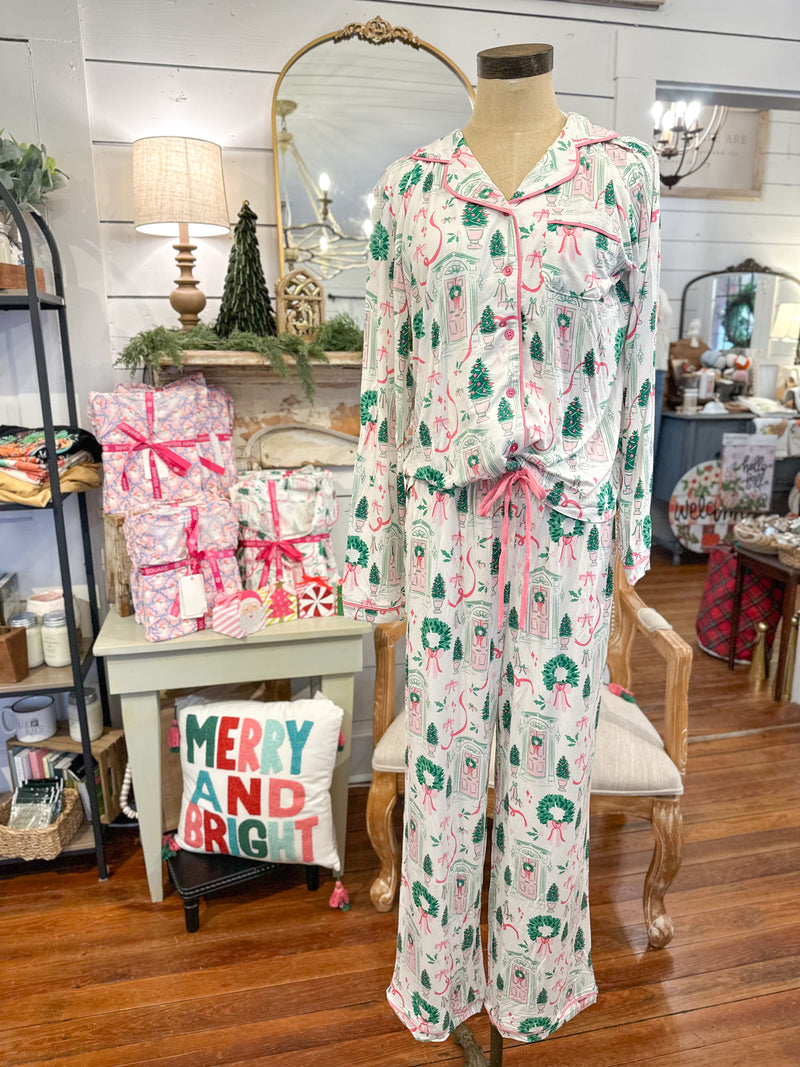 Christmas-themed pajama set on a mannequin in a decorated room with gift bags and festive decor.