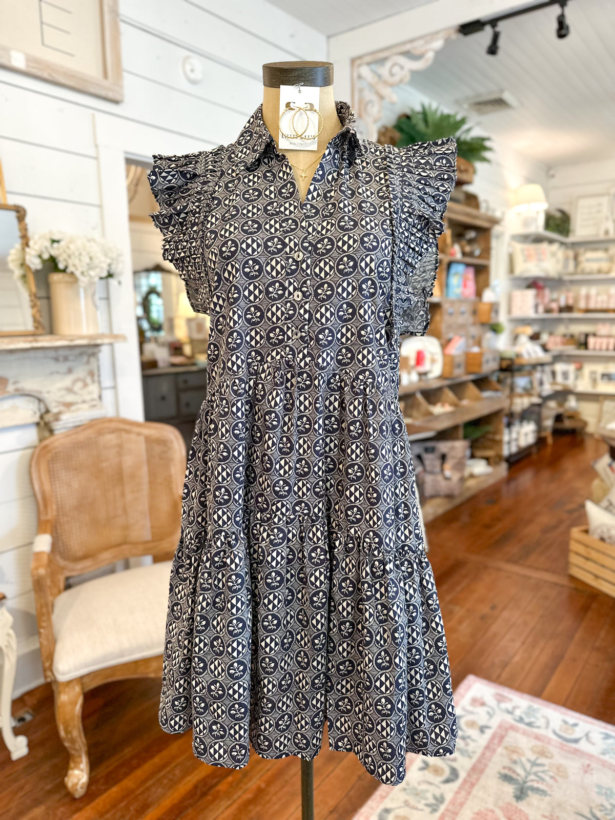 Patterned navy and cream dress on a mannequin in a store setting