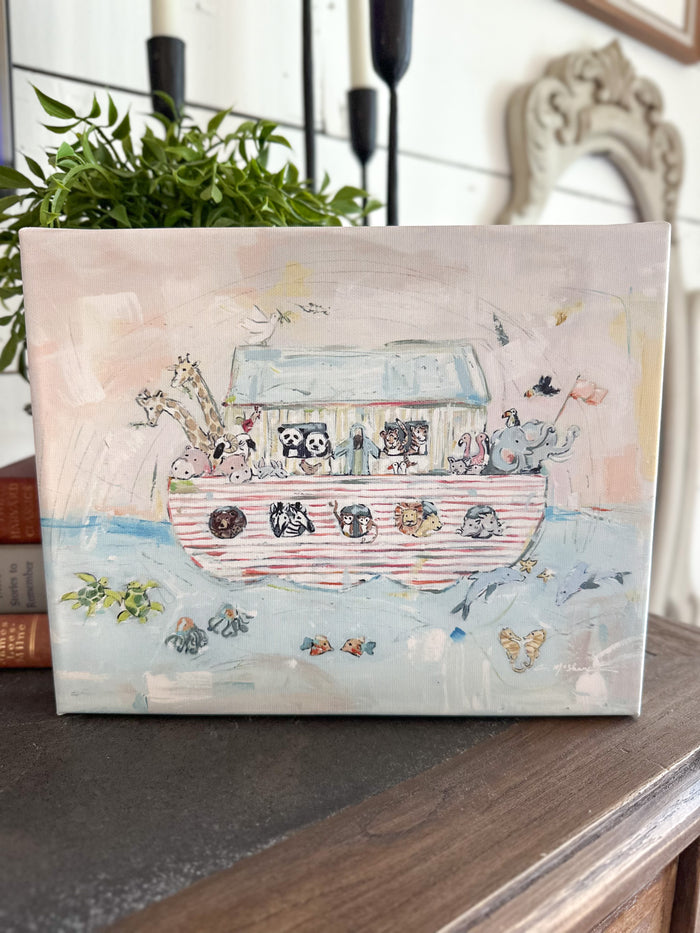 Canvas print of a Noah's Ark with animals on a wooden surface.