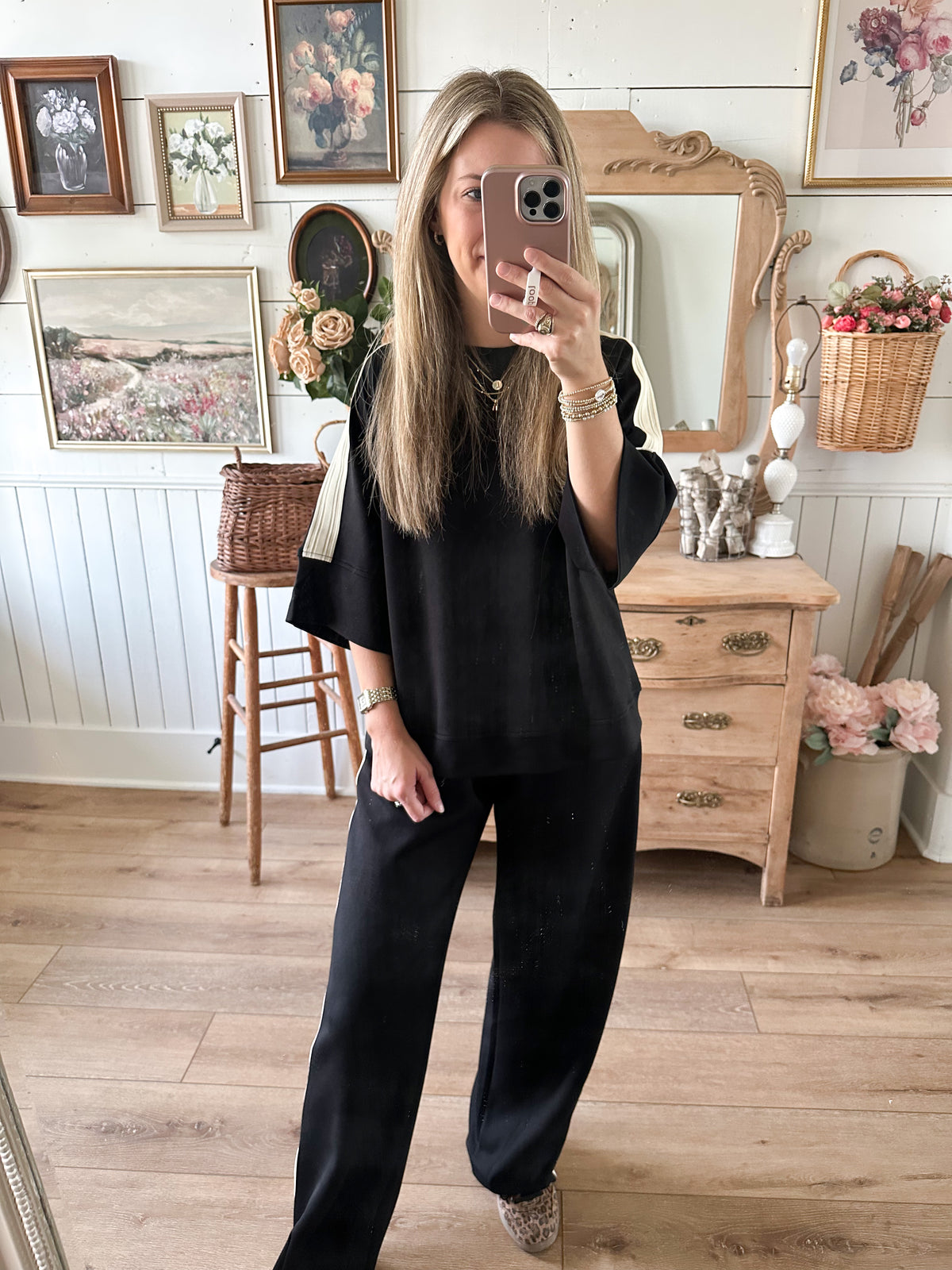 top untucked black loungewear set inside store setting pants 
