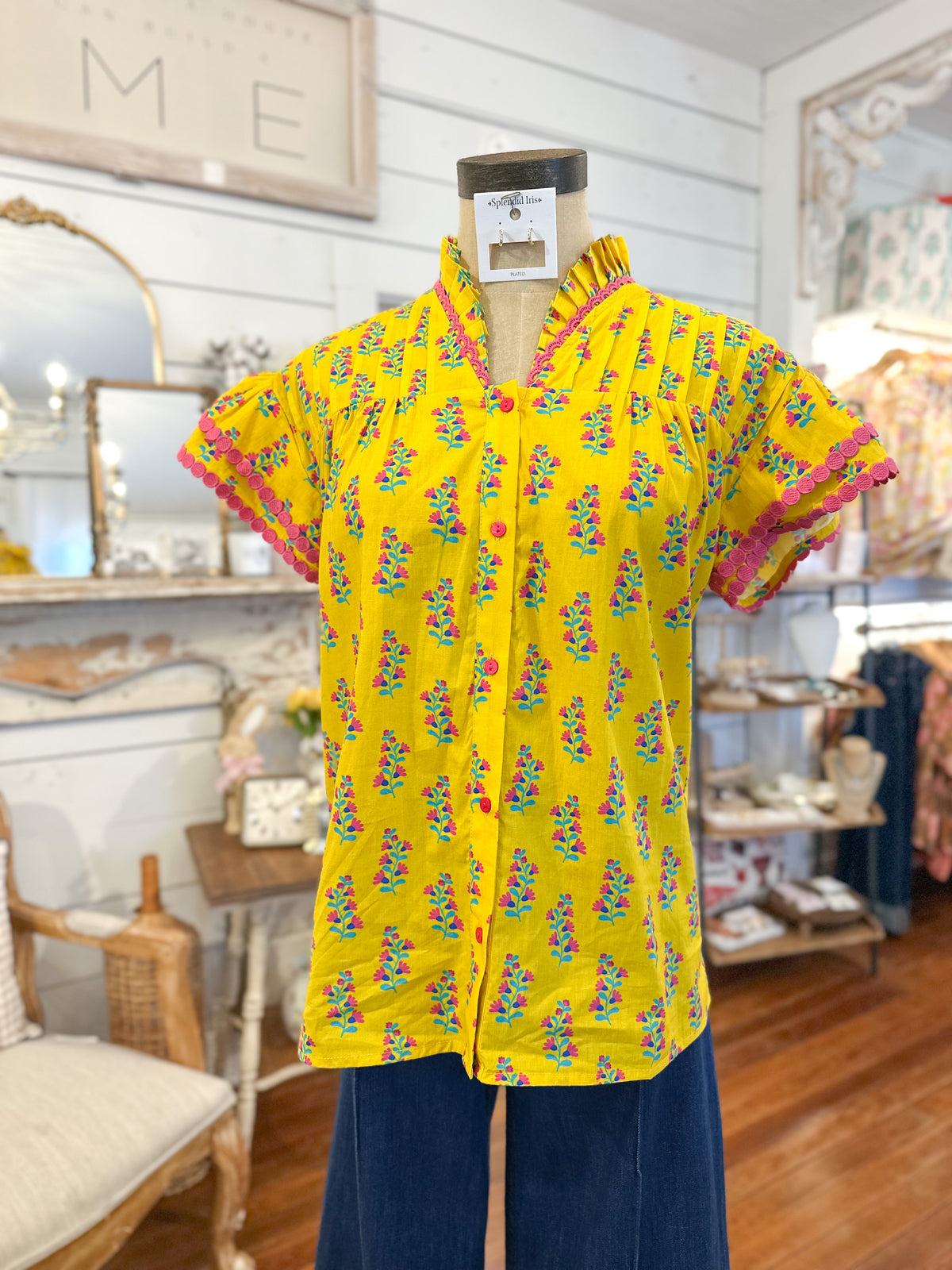 Yellow patterned shirt on a mannequin in a store setting