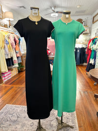 Black and green dresses on mannequins in a store setting