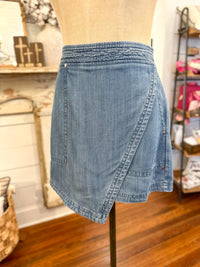 Denim skort on a mannequin in a store setting
