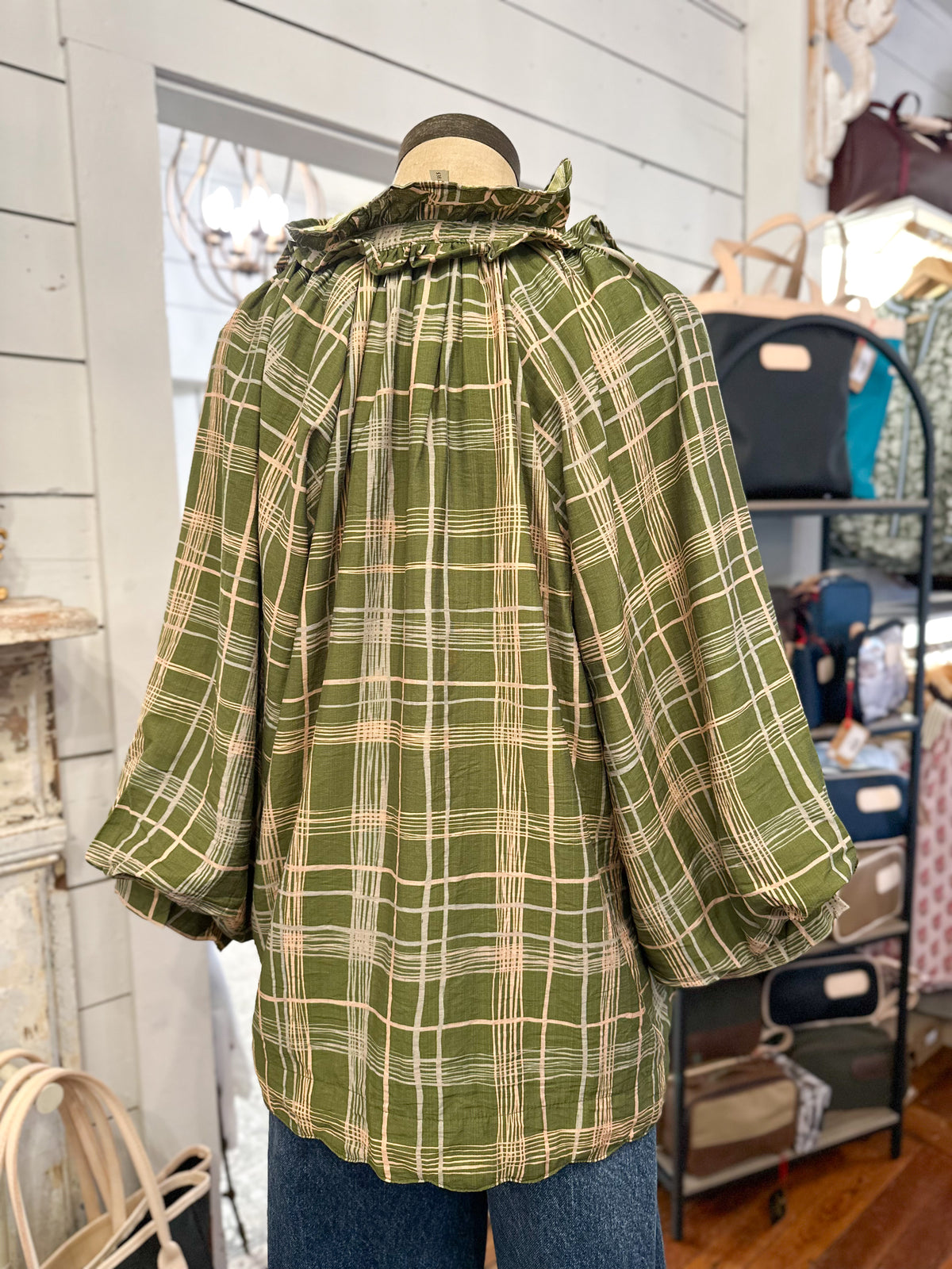 green plaid top umgee blouse inside  store setting back view 
