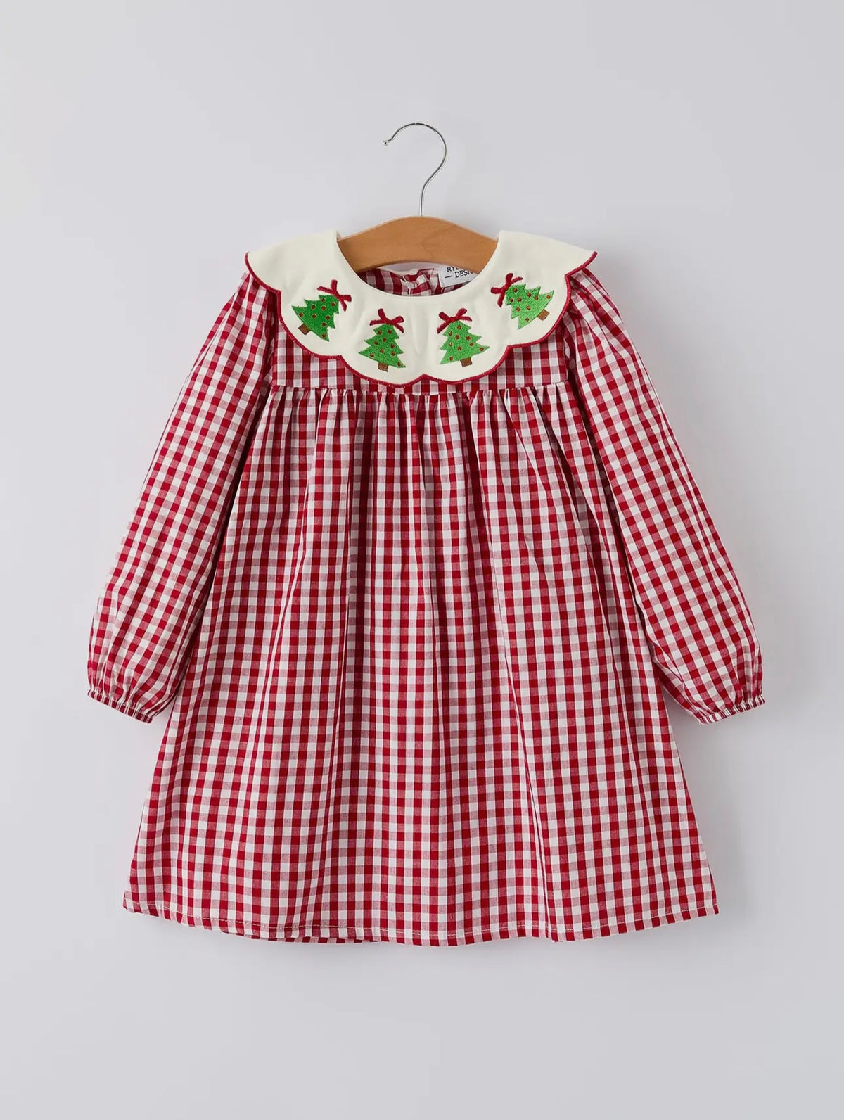 Red and white checkered dress with embroidered collar on a hanger against a light gray background