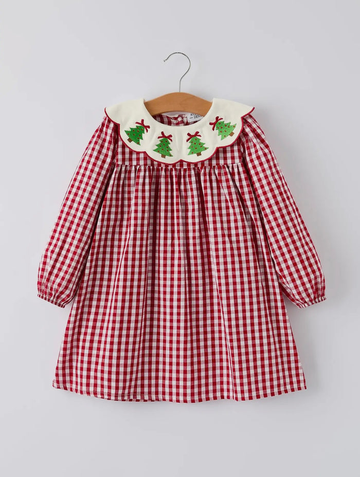 Red and white checkered dress with embroidered collar on a hanger against a light gray background