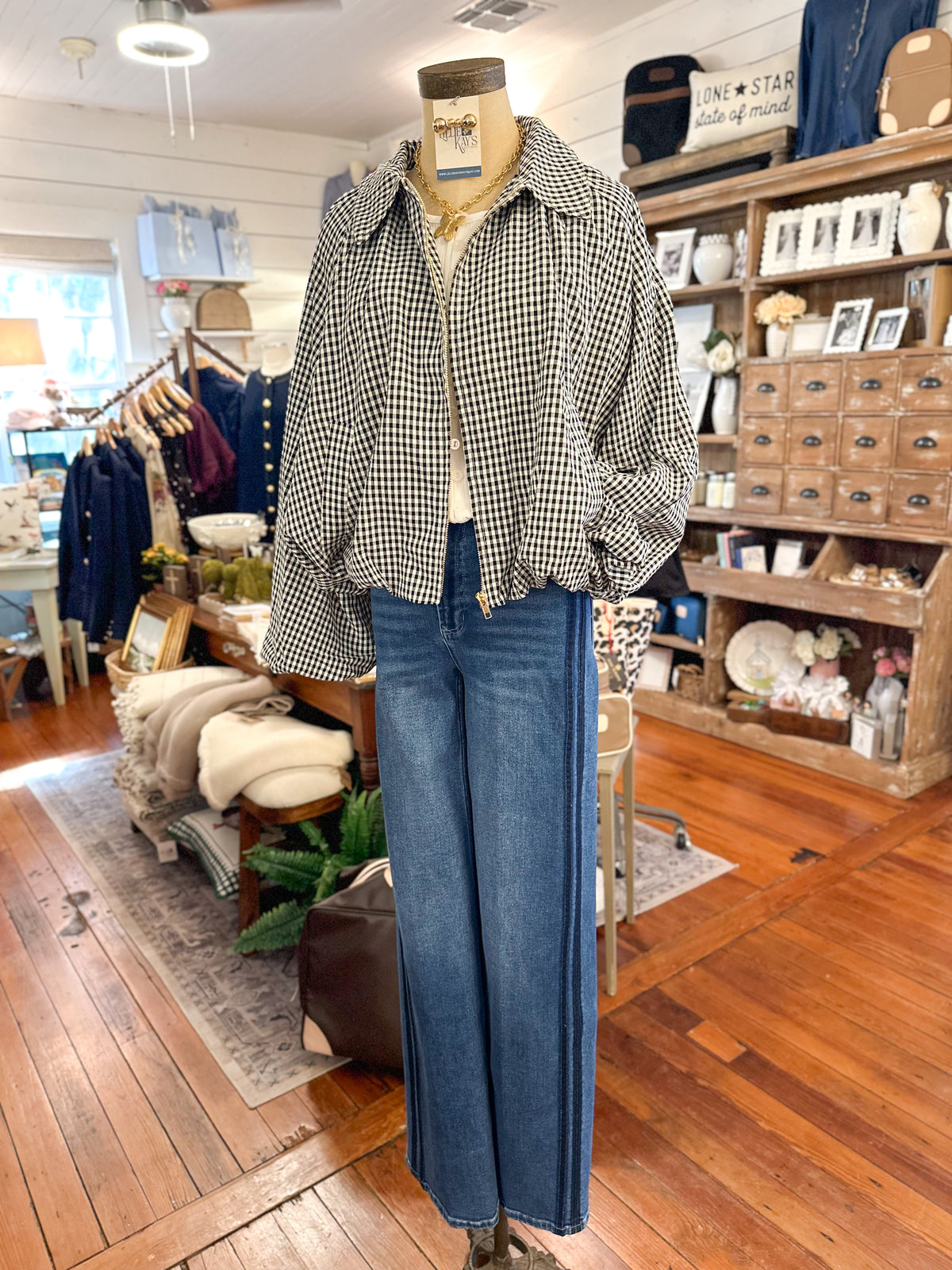 black and white jacket with bubble type sleeves and dear john denim jeans 
in store setting  