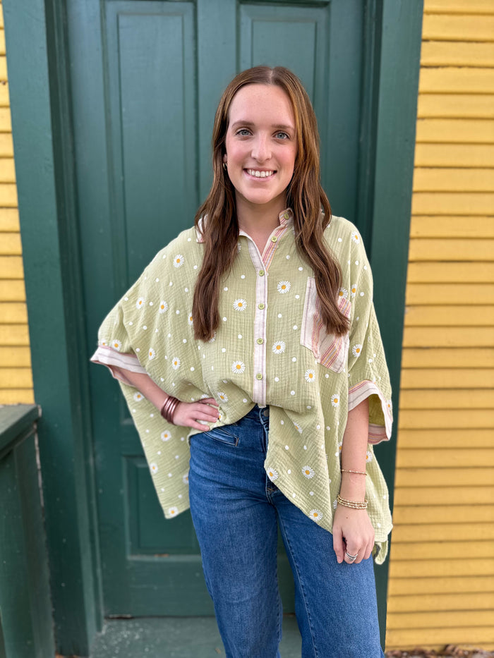 light green button down top with white daisys