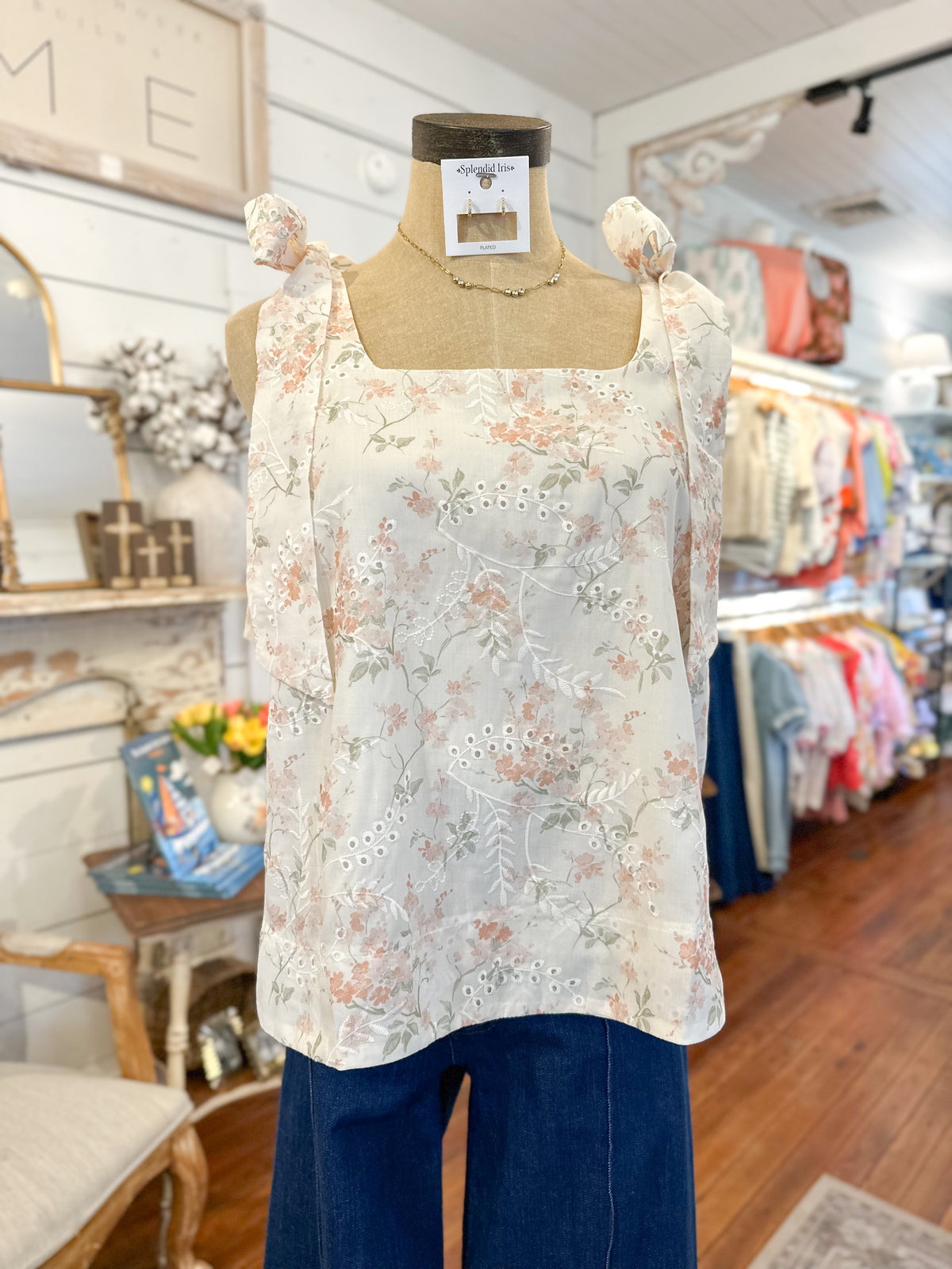 Floral top on a mannequin in a store setting
