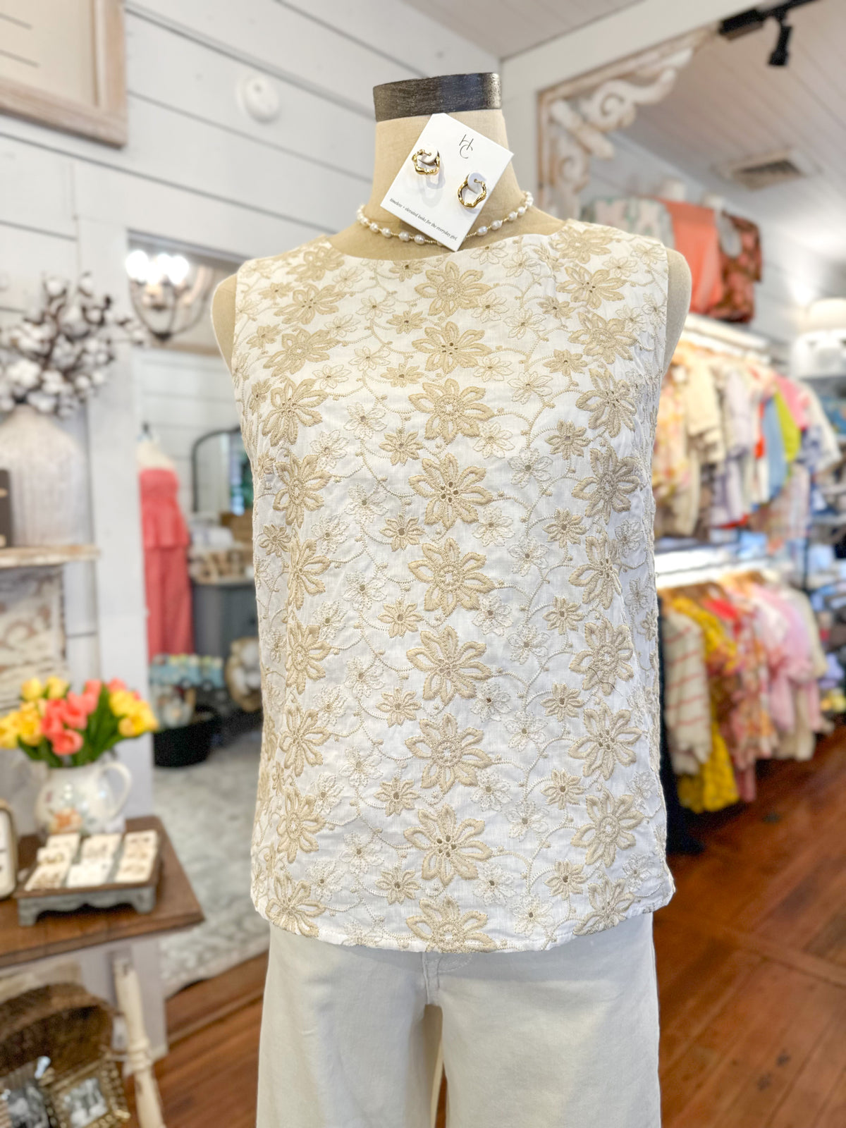 White lace top on a mannequin in a store setting