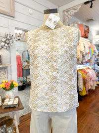 White lace top on a mannequin in a store setting