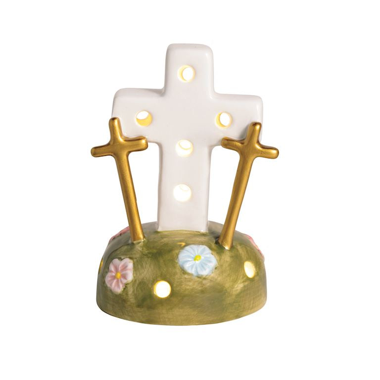 Decorative ceramic cross with floral designs on a white background