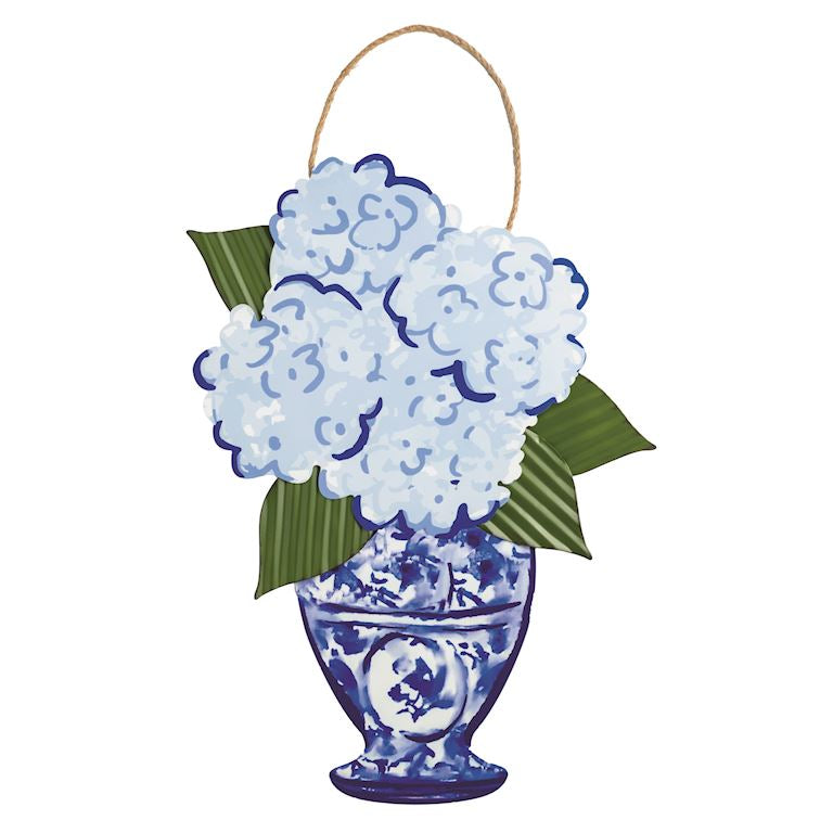 Decorative wall hanging with blue floral design and green leaves on a white background
