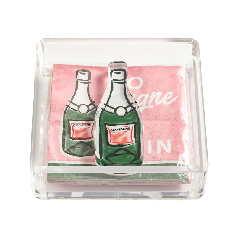 Pack of napkins with champagne bottle design in a clear holder on a white background mud pie 