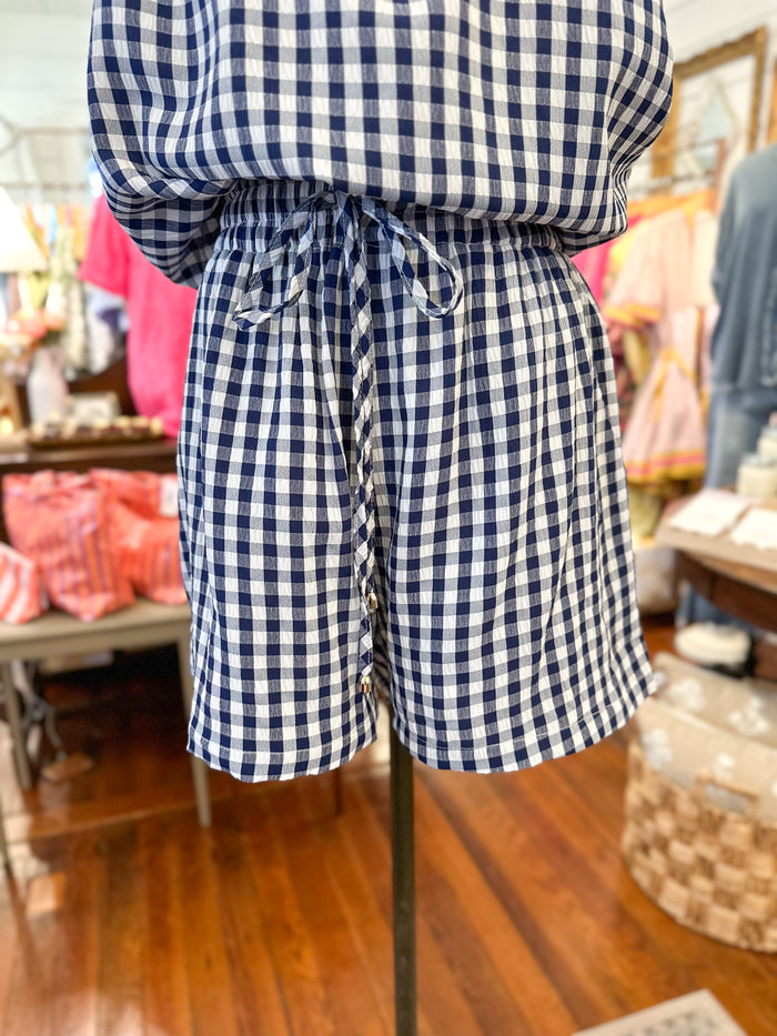 Person wearing a blue and white checkered outfit in a store setting