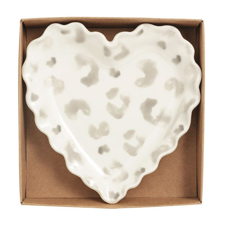 Heart-shaped ceramic dish with textured surface in a cardboard box