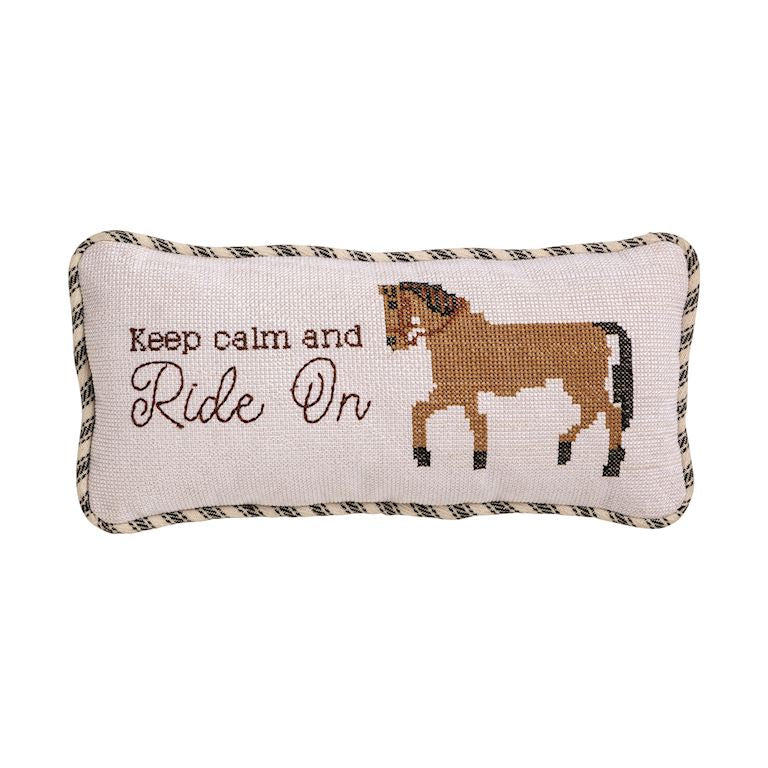 Decorative pillow with horse illustration and text 'Keep calm and Ride On' on a white background