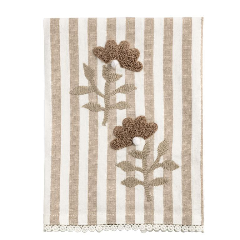 Striped towel with floral designs and a scalloped edge on a white background