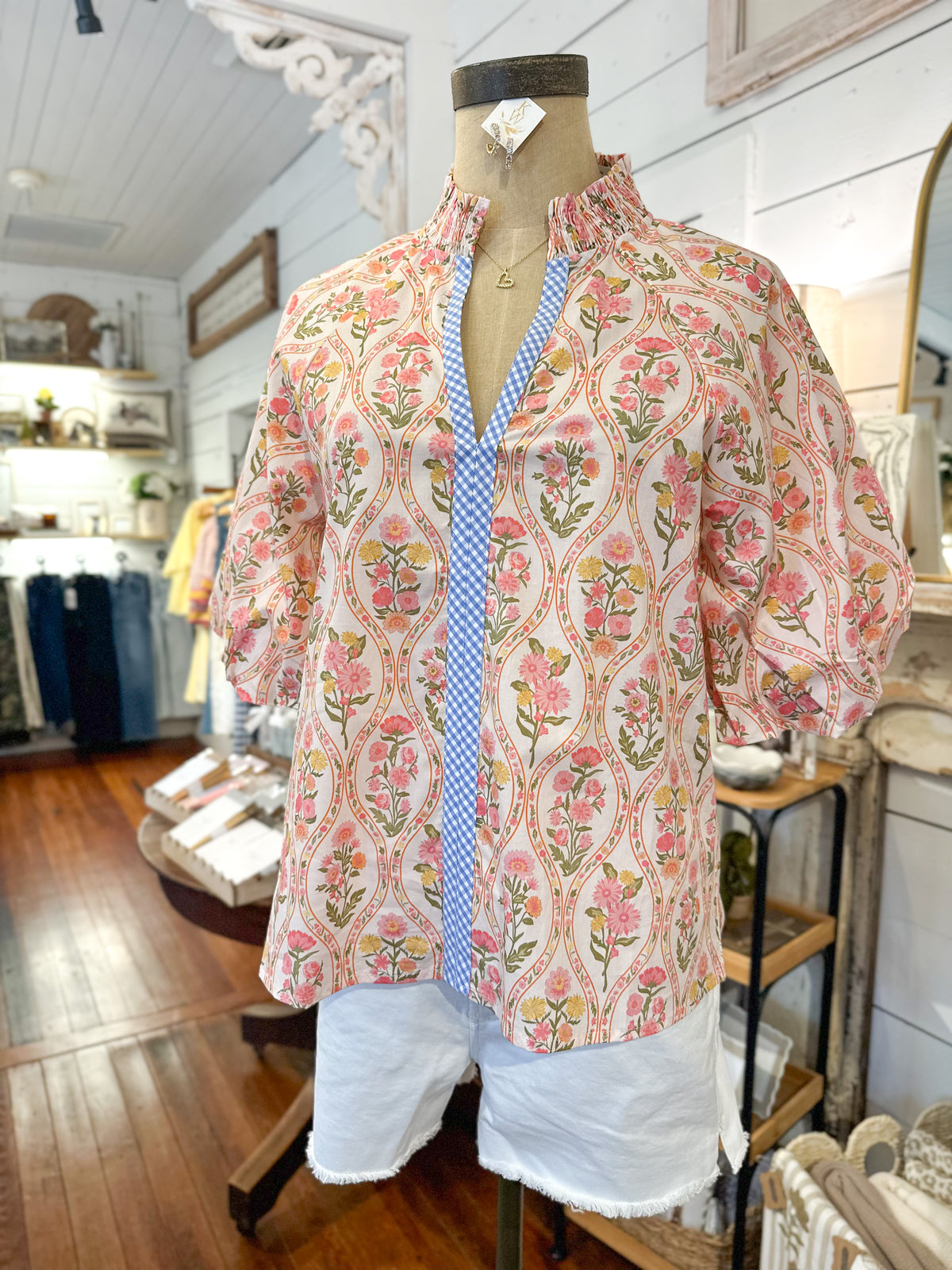 Floral blouse on a mannequin in a store setting