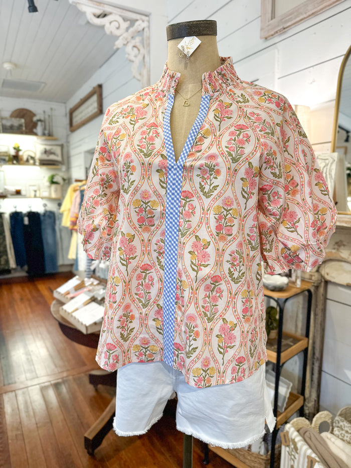 Floral blouse on a mannequin in a store setting