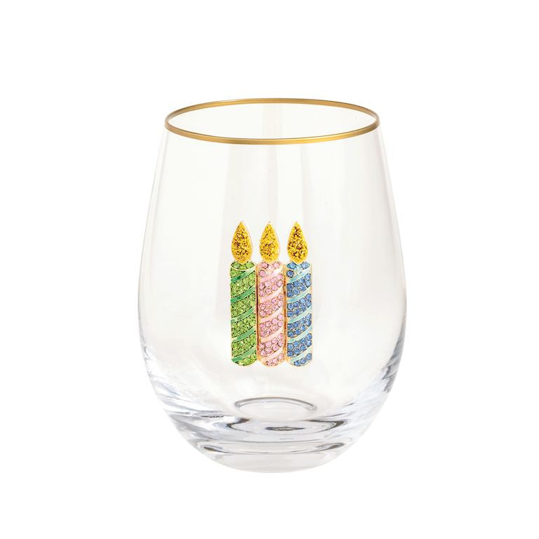 Clear glass with gold rim and colorful birthday candles design on a white background
