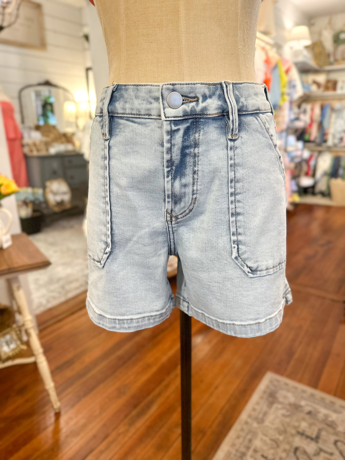 Light blue denim shorts on a mannequin in a store setting